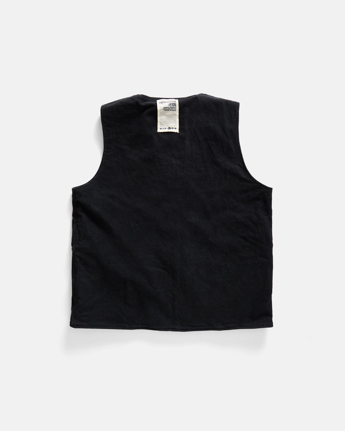 KEARSE REVERSIBLE UTILITY VEST - BARELY BLACKWATCH BEESWAX COATED COTTON TWILL AND BLACK COTTON CORDUROY