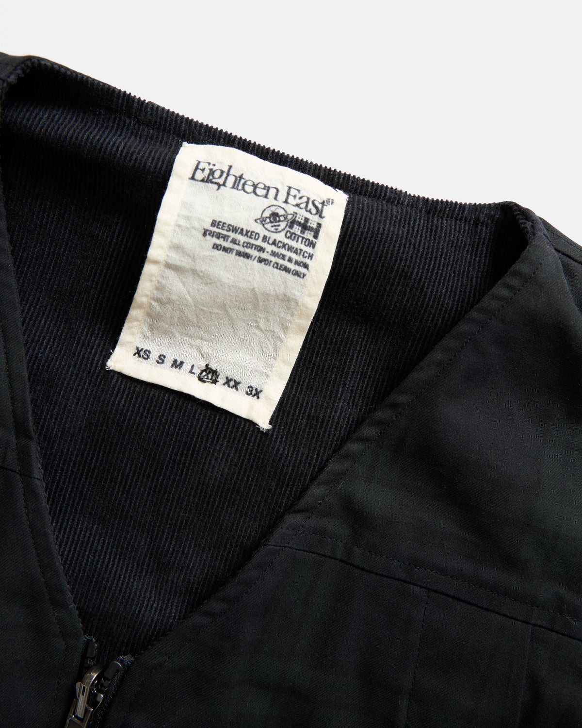 KEARSE REVERSIBLE UTILITY VEST - BARELY BLACKWATCH BEESWAX COATED COTTON TWILL AND BLACK COTTON CORDUROY